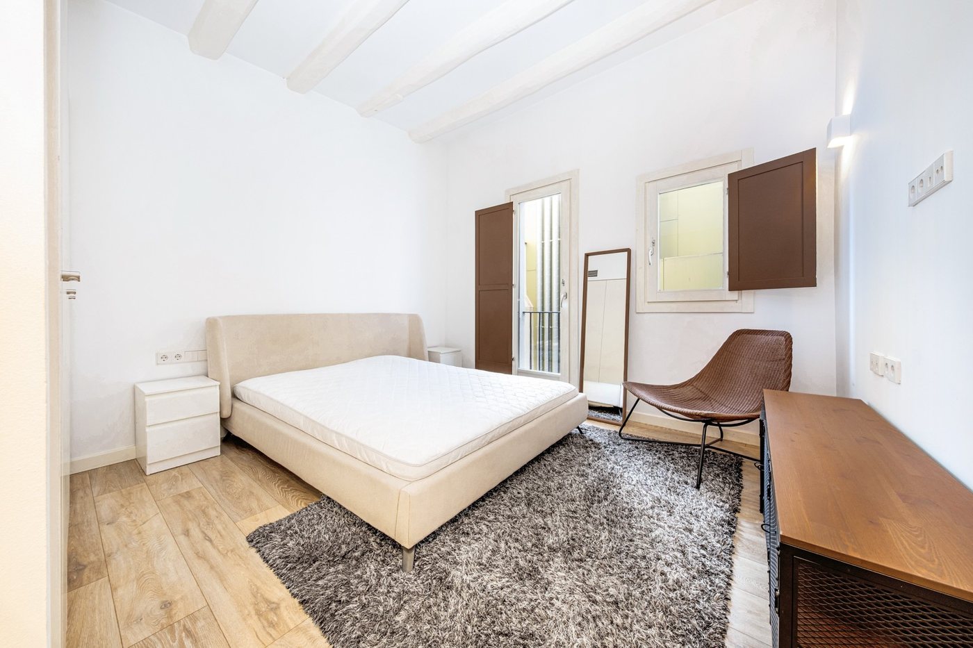Principal bedroom with balcony and shuttered window